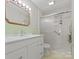 Bathroom featuring updated vanity, decorative tile, and a shower with sliding glass doors at 6401 Montpelier Rd, Charlotte, NC 28210
