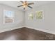 Bright bedroom features wood floors, trim and two windows allowing ample natural light at 6401 Montpelier Rd, Charlotte, NC 28210