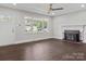 Bright living room with large windows, hardwood floors, and a charming fireplace feature at 6401 Montpelier Rd, Charlotte, NC 28210