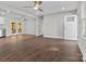Spacious living area with hardwood floors, a ceiling fan, and seamless flow to the outdoors at 6401 Montpelier Rd, Charlotte, NC 28210