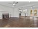 Open-concept living room with hardwood floors, a fireplace, and seamless flow to the kitchen at 6401 Montpelier Rd, Charlotte, NC 28210