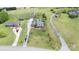 Stunning aerial view showcasing a well-maintained property with a pool, long driveway and lush green surroundings at 6419 Gilead Rd, Huntersville, NC 28078