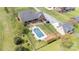 Aerial view of property featuring a large in-ground pool, landscaped grounds and a brick home with a covered patio at 6419 Gilead Rd, Huntersville, NC 28078