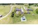 Aerial view of a sprawling estate featuring a pool, multiple buildings and manicured lawns in a serene setting at 6419 Gilead Rd, Huntersville, NC 28078
