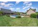 Large backyard featuring an in-ground pool and fence with mature trees at 6419 Gilead Rd, Huntersville, NC 28078