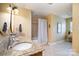 Bright bathroom featuring a double vanity with granite counters, tiled floors and a shower with a tub at 6419 Gilead Rd, Huntersville, NC 28078