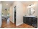 This bathroom has an open doorway to the closet, hardwood floors and a vanity area at 6419 Gilead Rd, Huntersville, NC 28078