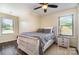 Serene bedroom features a plush bed with soft gray bedding, natural light and wood-look flooring for a cozy feel at 6419 Gilead Rd, Huntersville, NC 28078