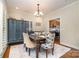 Cozy dining room with a large table, decorative cabinet and elegant furnishings at 6419 Gilead Rd, Huntersville, NC 28078