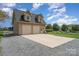 Detached garage and large concrete driveway with plenty of parking at 6419 Gilead Rd, Huntersville, NC 28078
