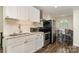 Updated kitchen features stainless steel appliances, granite countertops, white cabinets and an adjacent eat-in dining area at 6419 Gilead Rd, Huntersville, NC 28078