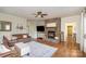 Warm living room with stone fireplace, hardwood floors, and ample seating for Gathering gatherings at 6419 Gilead Rd, Huntersville, NC 28078