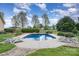 In-ground pool with lounge chairs and mature landscaping surrounded by a black metal fence at 6419 Gilead Rd, Huntersville, NC 28078