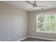 Comfortable bedroom featuring a ceiling fan and ample natural light from the large window for a cozy atmosphere at 643 Brickdust Ct, Fort Mill, SC 29708