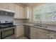 Modern kitchen with stainless steel appliances, granite countertops, and ample cabinet space at 643 Brickdust Ct, Fort Mill, SC 29708