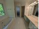 Bathroom featuring double sinks, tub, and shower with a view from the window at 6846 Beverly Springs Dr, Charlotte, NC 28270