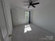 Cozy bedroom with neutral carpet, bright window, and ceiling fan for relaxation and comfort at 6846 Beverly Springs Dr, Charlotte, NC 28270