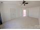 Bedroom with neutral carpet, ceiling fan, and a glimpse into an adjoining room at 6846 Beverly Springs Dr, Charlotte, NC 28270