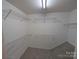 Walk-in closet with wire shelving and neutral carpet at 6846 Beverly Springs Dr, Charlotte, NC 28270