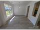 Bright dining room with large window, neutral walls, and modern light fixture for inviting meals at 6846 Beverly Springs Dr, Charlotte, NC 28270