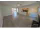 Open living room showcasing fireplace, ceiling fan, bright lighting, and open access to the kitchen at 6846 Beverly Springs Dr, Charlotte, NC 28270