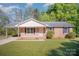 Charming brick ranch home with a covered carport, inviting curb appeal, and landscaped front yard at 700 Fine Wright Ave, York, SC 29745