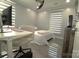 Bright bedroom features modern decor, a ceiling fan, and light-blocking window blinds at 7428 Beaufort Cir, Charlotte, NC 28227
