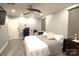 Bright bedroom with modern ceiling fan, gray tones, and a dedicated workspace at 7428 Beaufort Cir, Charlotte, NC 28227