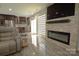 The modern living room boasts stone fireplace, stainless appliances and open concept design at 7428 Beaufort Cir, Charlotte, NC 28227