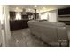 Open concept living area showcases modern kitchen, stone fireplace and a comfortable seating arrangement at 7428 Beaufort Cir, Charlotte, NC 28227