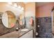 Bathroom featuring granite countertop, round mirrors, and tiled shower at 7444 Hurstbourne Green Dr, Charlotte, NC 28277