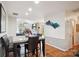 Elegant dining area with modern lighting fixtures and a view into the living room at 7444 Hurstbourne Green Dr, Charlotte, NC 28277