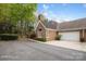 Beautiful exterior showcasing an attached garage, and landscaped garden under a sunny sky at 7444 Hurstbourne Green Dr, Charlotte, NC 28277