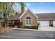 Charming brick home featuring an attached two-car garage and well-manicured landscaping at 7444 Hurstbourne Green Dr, Charlotte, NC 28277