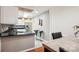 Modern kitchen with white cabinetry, granite countertops, and stainless steel appliances at 7444 Hurstbourne Green Dr, Charlotte, NC 28277