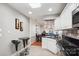 Kitchen featuring stainless steel appliances, breakfast bar, and tile flooring at 7444 Hurstbourne Green Dr, Charlotte, NC 28277