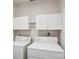 Laundry room featuring washer, dryer, and storage cabinets at 7444 Hurstbourne Green Dr, Charlotte, NC 28277