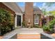 Inviting patio with a decorative water fountain, lovely landscaping, and elegant brick details at 7444 Hurstbourne Green Dr, Charlotte, NC 28277