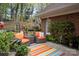 Comfortable patio with outdoor seating, brick exterior, and colorful striped rug at 7444 Hurstbourne Green Dr, Charlotte, NC 28277