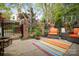 Charming patio with comfortable outdoor seating, lush garden views, and decorative water fountain at 7444 Hurstbourne Green Dr, Charlotte, NC 28277
