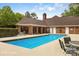 Community pool with lounge chairs, shady spots, and clean blue water at 7444 Hurstbourne Green Dr, Charlotte, NC 28277