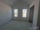 Bright, new bedroom space with tall ceiling that has natural light, perfect for customization at 8038 Pawtuckett Rd, Charlotte, NC 28214