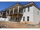 Two-story home features a large wooden balcony overlooking an unfinished yard at 8038 Pawtuckett Rd, Charlotte, NC 28214
