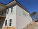 Exterior of new home construction with windows and partial siding at 8038 Pawtuckett Rd, Charlotte, NC 28214