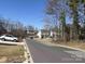 Neighborhood street view with parked cars and trees on a sunny day at 8038 Pawtuckett Rd, Charlotte, NC 28214