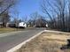 Neighborhood street view with houses and bare trees on a clear day at 8038 Pawtuckett Rd, Charlotte, NC 28214