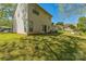 A spacious back yard featuring lush grass and mature trees offering a serene outdoor retreat and space to relax at 8719 Sweet Sage Ln, Charlotte, NC 28227