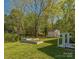 A tranquil backyard featuring a well-manicured lawn, storage shed, and planter boxes, ideal for outdoor enjoyment at 8719 Sweet Sage Ln, Charlotte, NC 28227