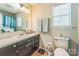Bathroom with a single sink vanity, toilet, and a shower/tub combo, offering essential amenities at 8719 Sweet Sage Ln, Charlotte, NC 28227