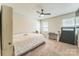 Well-lit bedroom featuring a comfortable bed, a ceiling fan, and a writing desk, offering a versatile space at 8719 Sweet Sage Ln, Charlotte, NC 28227